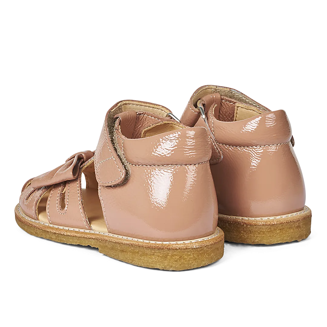 Starter sandal with a bow and velcro closure