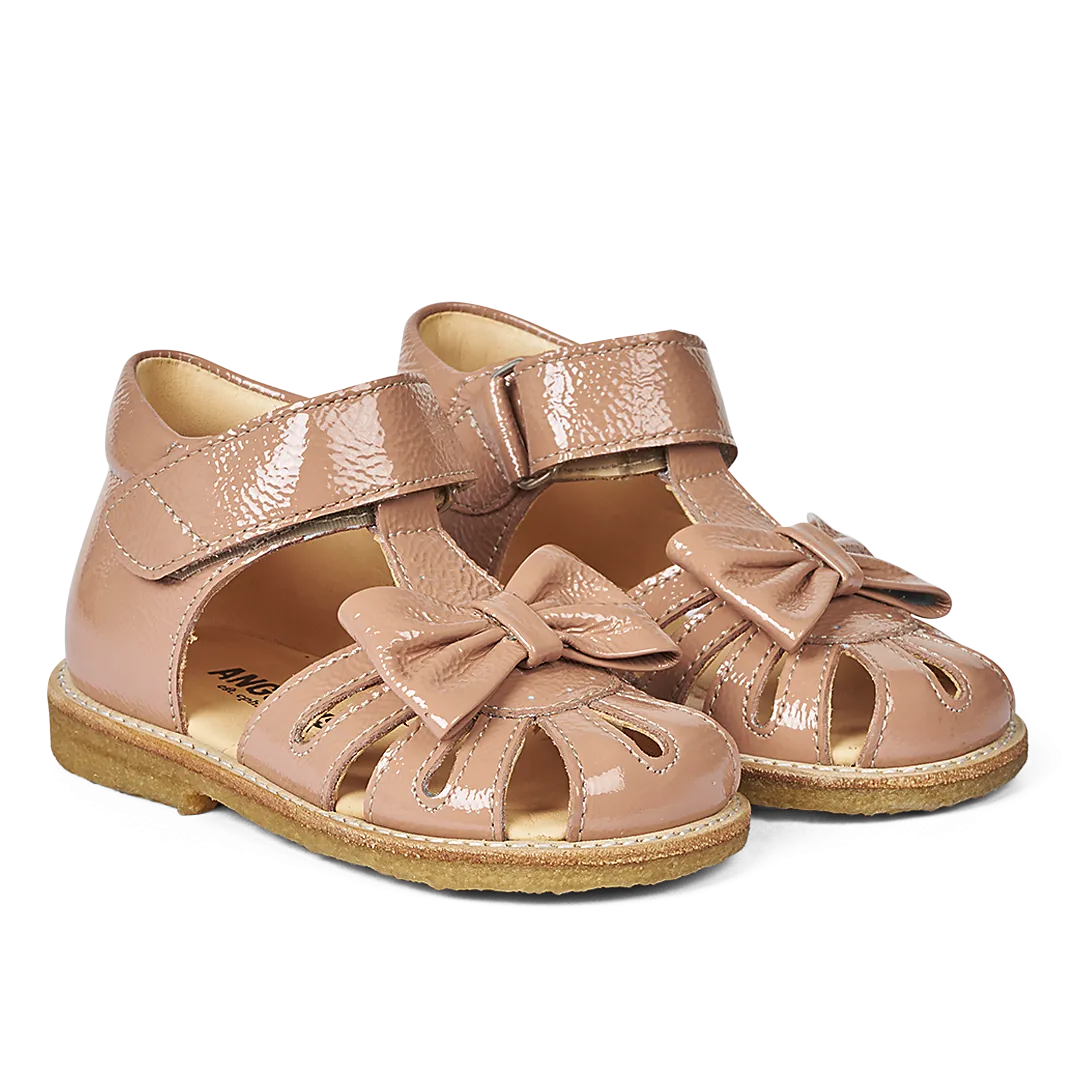 Starter sandal with a bow and velcro closure