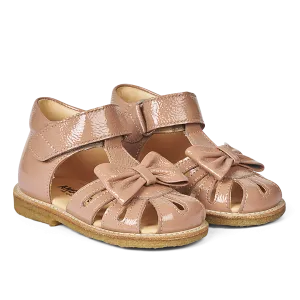 Starter sandal with a bow and velcro closure